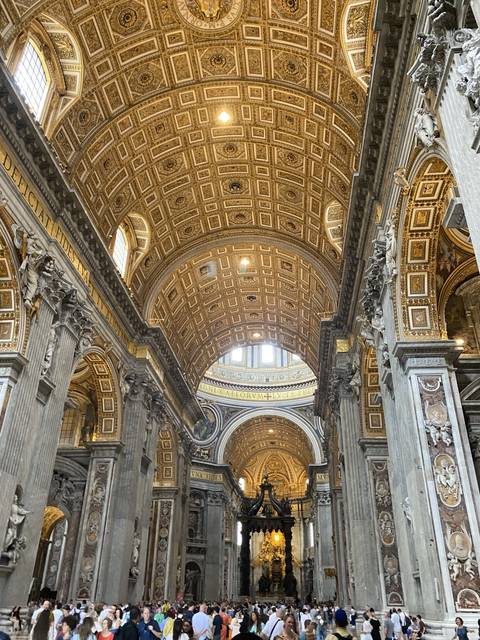       Interior of a lavish church with golden decorations.
  