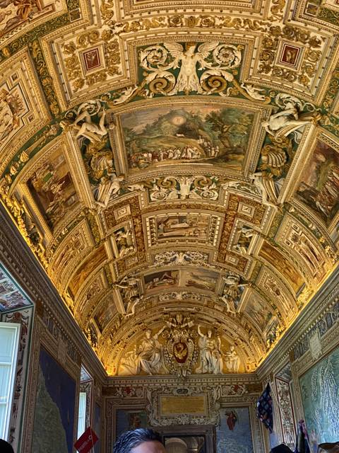       Ceiling with intricate paintings and sculptures.
  