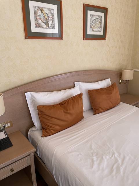       Upscale bedroom with decorative pillows and artwork.
  