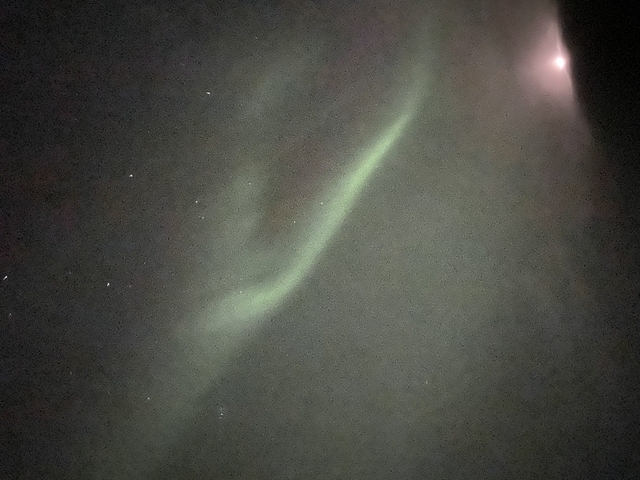 Green aurora borealis lighting up the night sky.