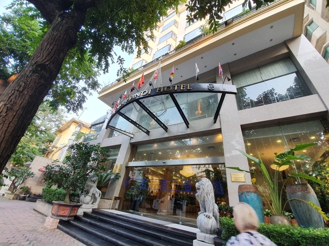       Entrance of a hotel with international flags.
  