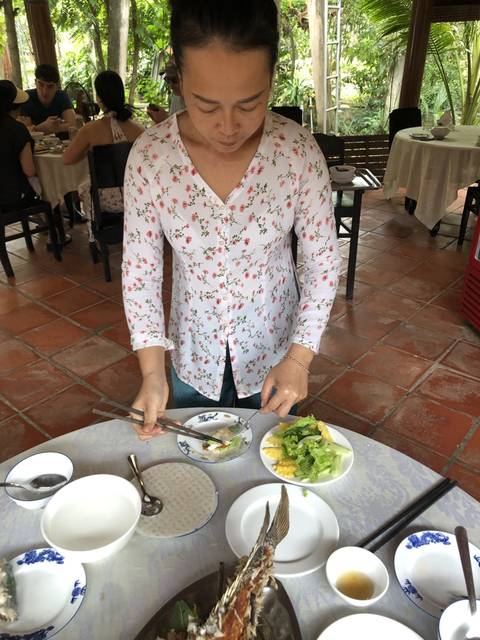       Person serving a meal at a restaurant.
  