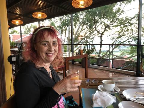       Upside-down image of a woman with a drink in a café.
  