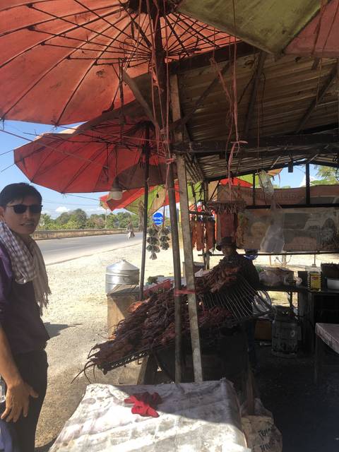       Upside-down image of a roadside market with grilled food.
  