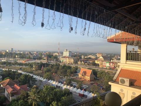Cityscape view with buildings and a decorative fence in the foreground.