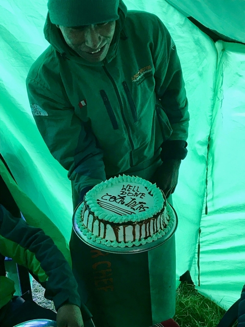       Person holding a congratulatory cake.
  