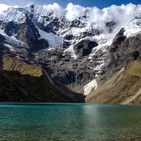       Mountain lake with snow-capped peaks in the background.
  