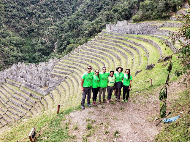       Group in front of ancient terraces at an archaeological site.
  