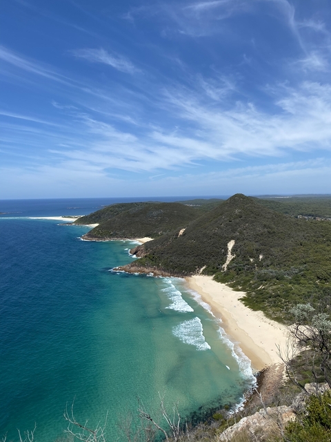       Coastal landscape with hills and ocean.
  