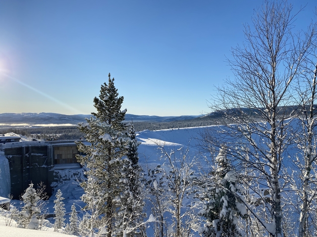Snowy landscape with distant mountain views.