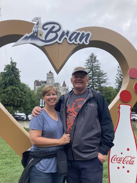Couple posing in front of a Bran sign