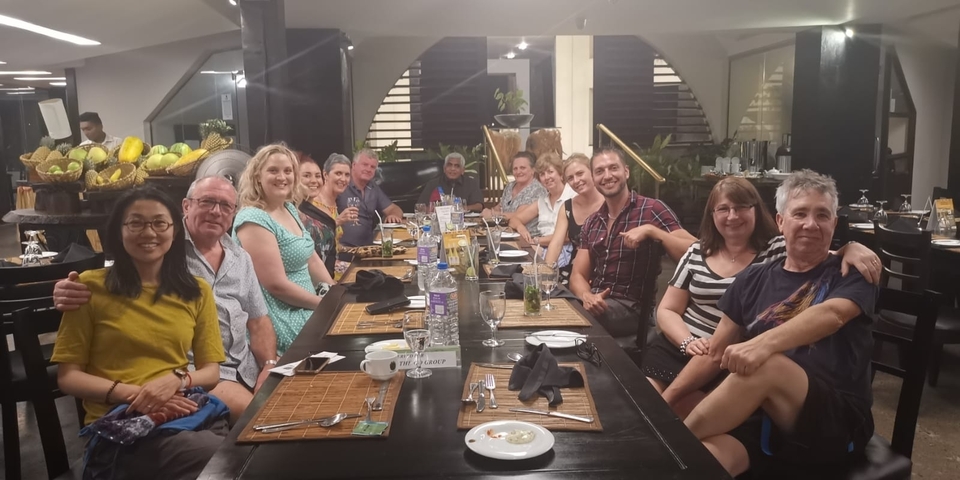       Group of people dining together.
  