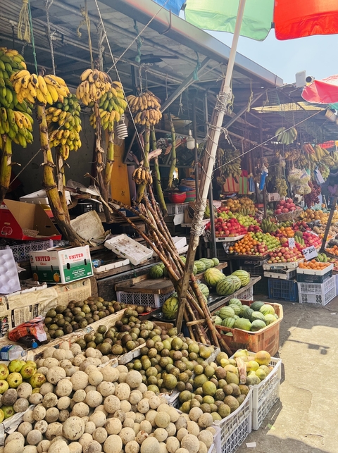 Fruit and vegetable market with various produce.