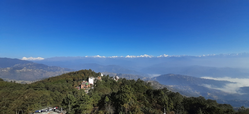 Scenic view of hills and mountains under a clear sky.