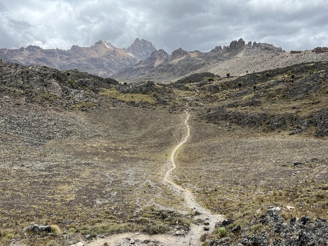       A winding path in a dry mountainous landscape.
  