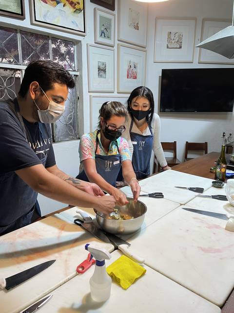       Group of people cooking in a class
  