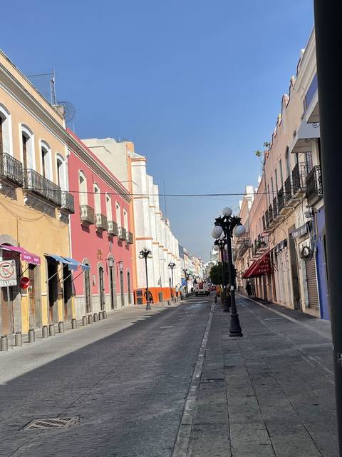       City street with colorful buildings and lamp posts
  