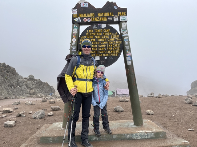 Father and child at Lava Tower Camp with sign.
