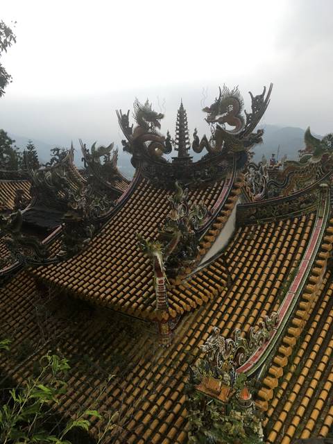 Elaborately decorated temple roof with intricate details.