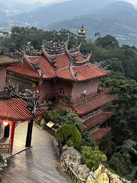 Temple with a view of the forested landscape.