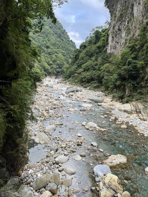 Rocky riverbed in a green valley.