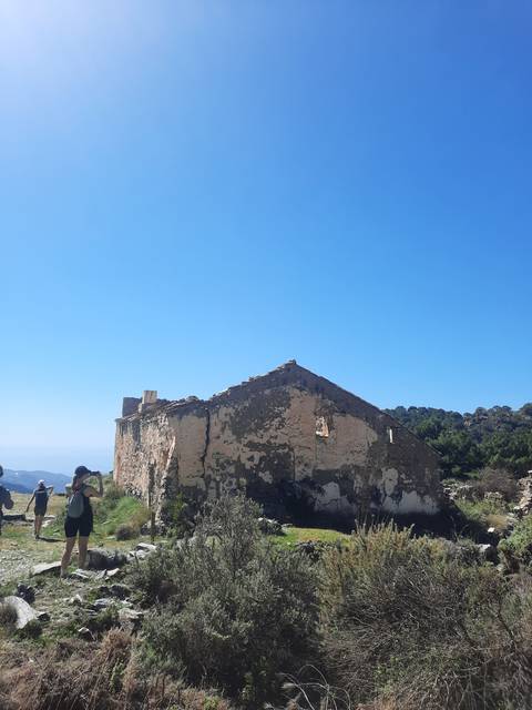 Old stone building ruins against a clear blue sky.