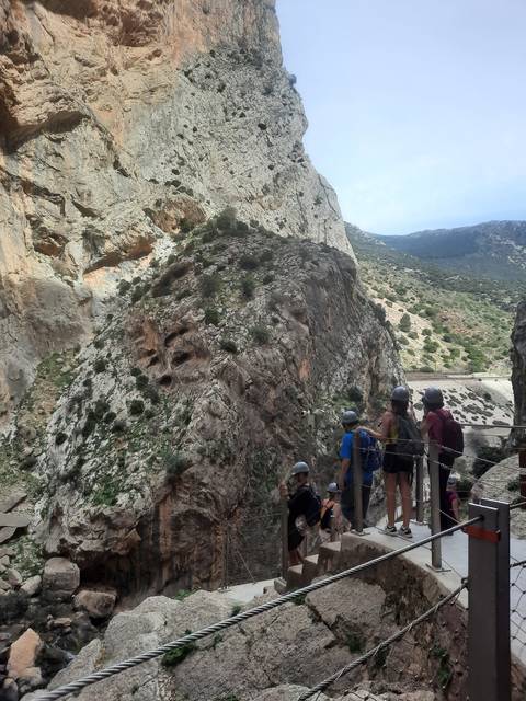       Group of hikers on a cliffside walk
  