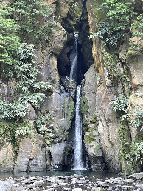       Waterfall flowing into rocky pools.
  