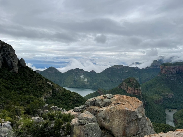       Scenic view of mountains with clouds and a river below.
  