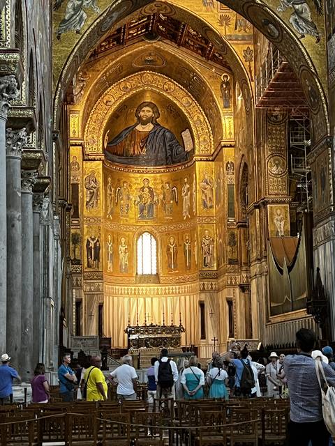      Interior of a church with a large ornate mosaic design on the ceiling.
  