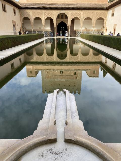 Architectural reflection in a pool.