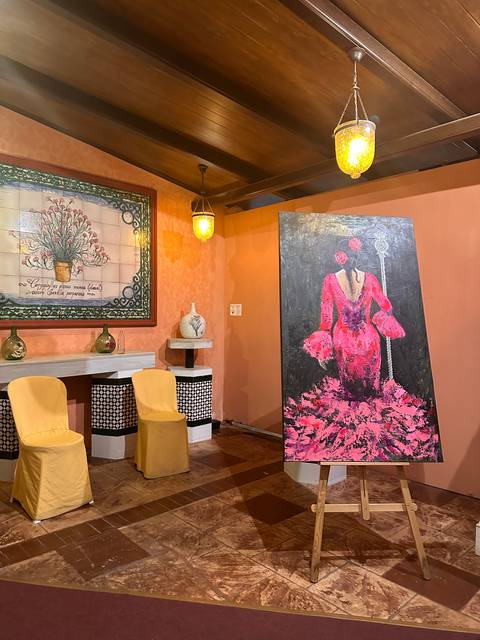       Artistic interior with vibrant colors and paintings.
  