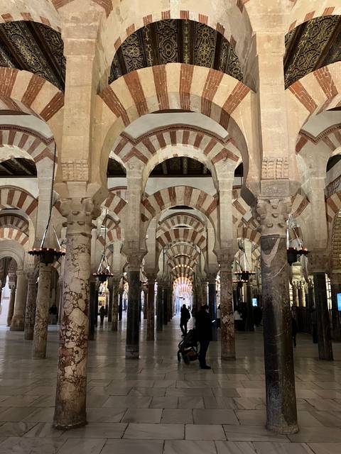 Interior of a historic building with arches and decorative elements.