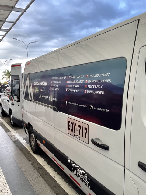 Decorated vehicle with promotional graphics in a parking area.