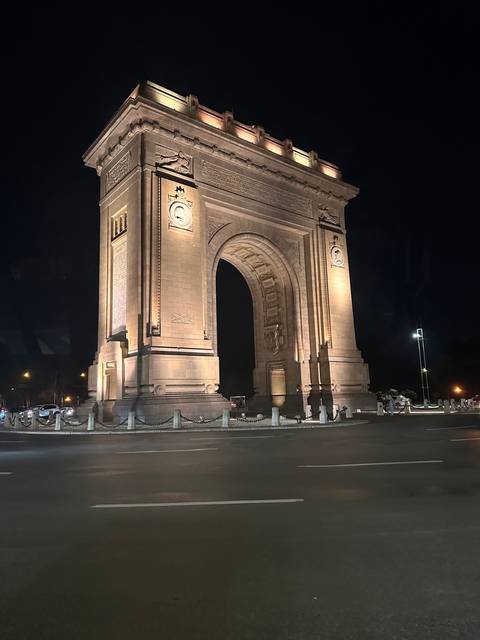       An illuminated archway structure at night.
  