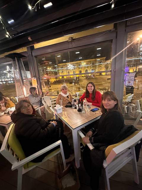       Group of people dining indoors.
  