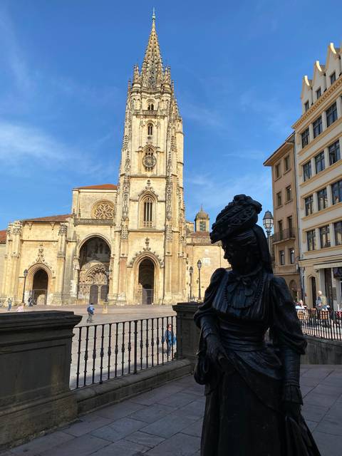 Gothic cathedral with a sculpture in front.