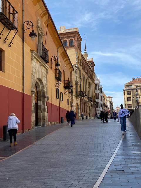 People walking on a street in a historic city center.
