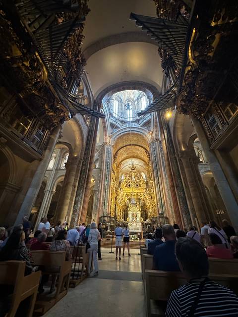       Interior of a grand, ornately decorated cathedral.
  
