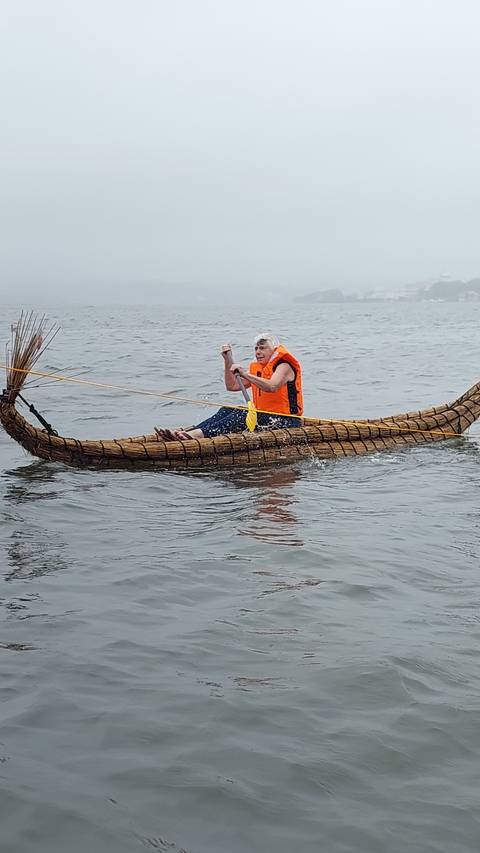 Person in a canoe on a body of water.