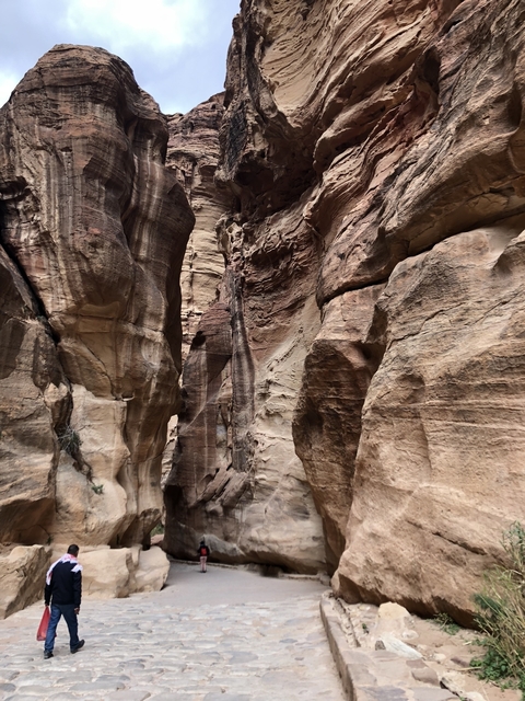 A narrow canyon with high rock cliffs.