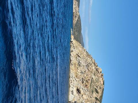 Upside-down view of the sea and rocky coastline.