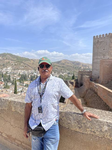 Person posing with a scenic view in the background.