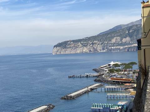       Coastal view with cliffs and seaside structures.
  
