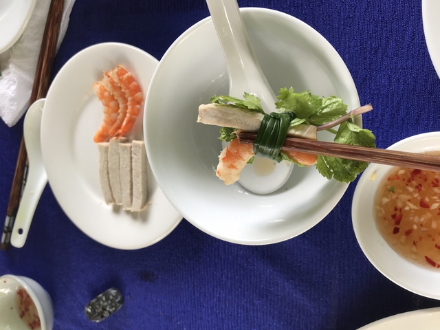 Spring roll ingredients laid out with chopsticks.