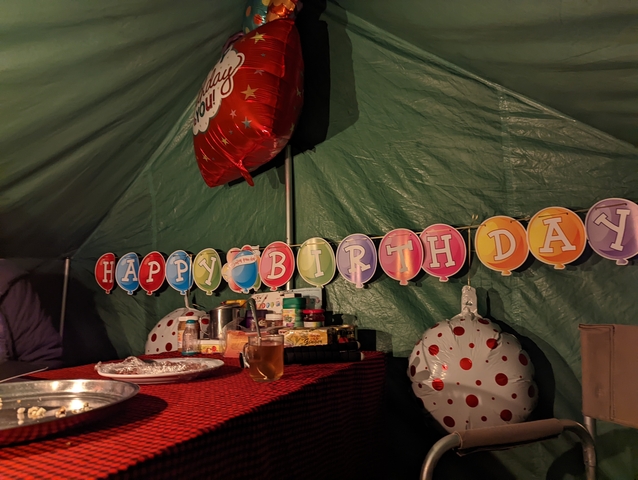       Inside view of a decorated tent with birthday banners.
  