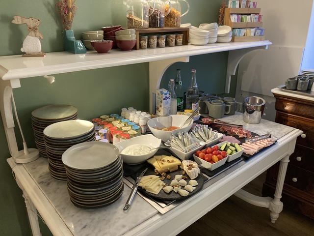 Assortment of food items, including cheeses and meats, on a counter.