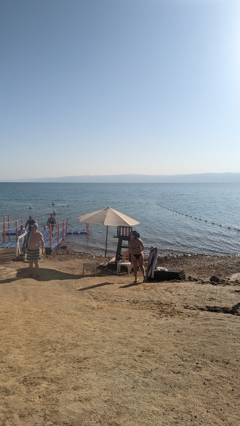 People enjoying a beach day by the Dead Sea.