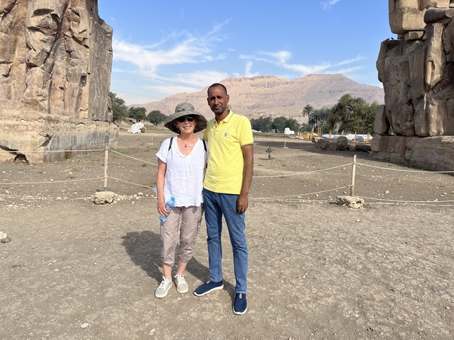A couple standing in front of ancient ruins.