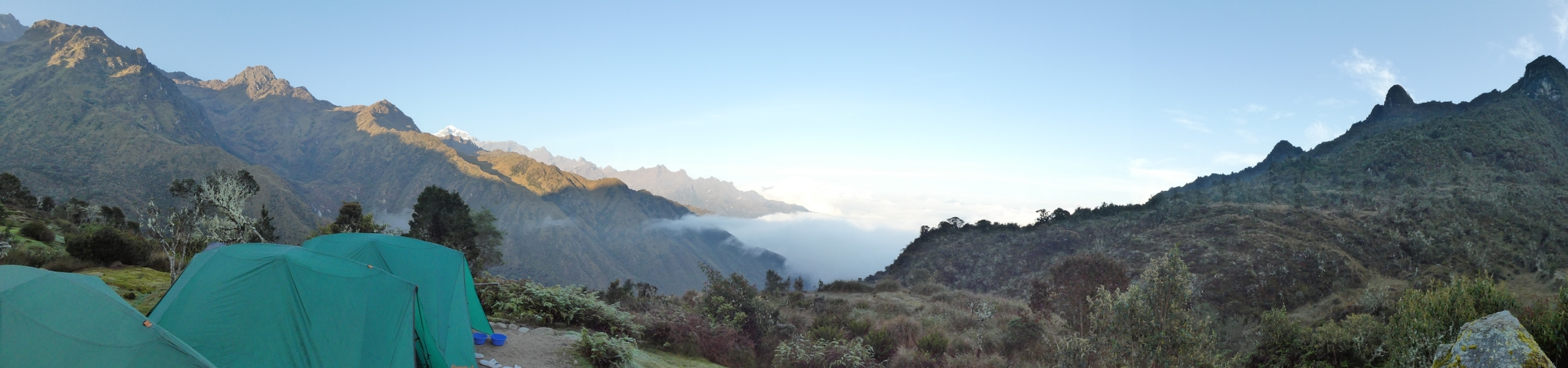 A panoramic view of mountain ranges with clouds below.